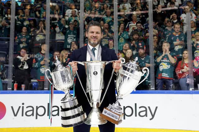 Adam Keefe hoisting the Challenge Cup, Elite League trophy, and Elite League Playoff trophy after the Belfast Giants completed the 2022/23 treble. Photo by William Cherry/Presseye