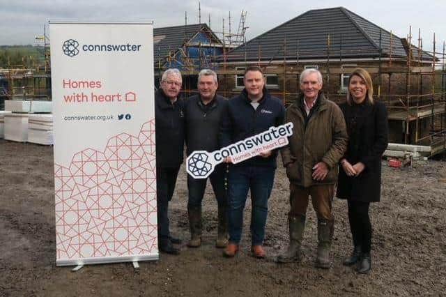 Caption Cllr Mark Cooper BEM (centre) at the new Connswater Housing development site in Monkstown.