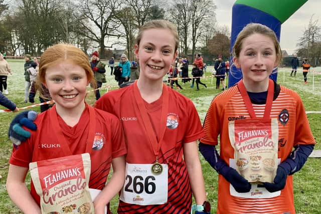Moira Primary School pupils Sarah Holland in 2nd place, Rachel Holland in 1st place and Alanna Matthews from Christian Brothers’ Primary School, Armagh in 3rd place in the second girls’ race at the second round of the 2023-2024 Flahavan’s Athletics NI Primary School Cross Country League which took place at Lurgan Park.  Pic credit: Morrow Communications