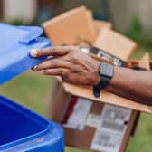 Image of a householder recycling carboard material. Photo issued by Mid and East Antrim Borough Council.