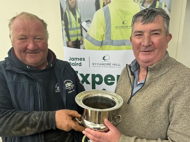 William Gill receives his trophy from host Mr James Baird for winning the Vintage Senior Class at Listooder Ploughing match. William was Reserve Vintage Champion