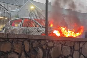 A vehicle was set alight at the height of the disorder. Photo: Pacemaker