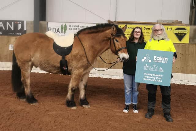 Pony Max models the specially designed sheepskin padded saddle, which will improve quality of life for many local disabled riders, joined by Eakin Healthcare nominator Philip Clyde and his daughter Makenzie. CREDIT EAKIN HEALTHCARE