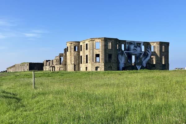 The towering new piece of work We Can Do Better by acclaimed artist Joe Caslin has taken over Downhill House.