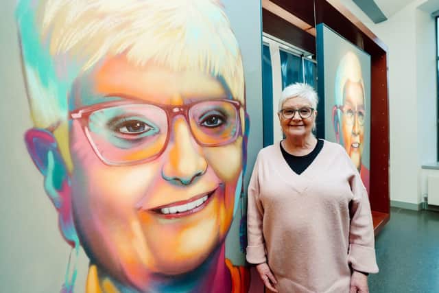 Peace Heroine Anne Carr poses with her portrait. (Pic: Contributed).