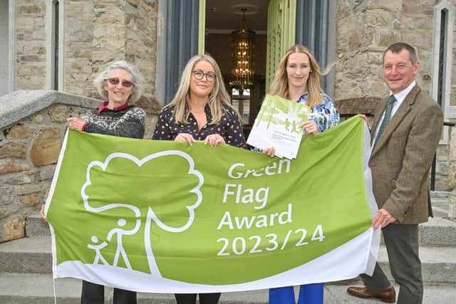 Professor Sue Christie OBE, Chair at Keep NI Beautiful (left) and Dr Ian Humphreys, CEO, Keep NI Beautiful (right) help Tara McAleese and Claire Duddy celebrate three Green Flag Awards for Mid and East Antrim Borough Council.  Photo: Simon Graham
