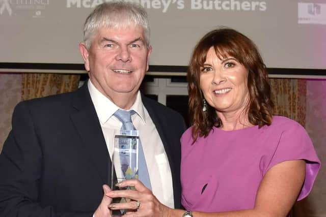 Winner of the Lifetime Achievement Award at the 2022 Mid Ulster Business Awards, Oran McAtamney owner of McAtamney's Butchers with Julie McKeown, of main sponsors, Henry Brothers. MU46-220