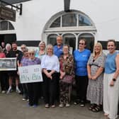 Deputy Mayor of Causeway Coast and Glens Borough Council, Alderman Sandra Hunter, with Councillors Margaret Anne McKillop and Cara McShane, Stella Byrne, Head of Investment at The National Lottery Heritage Fund, and volunteers from the Friends of Ballycastle Museum.