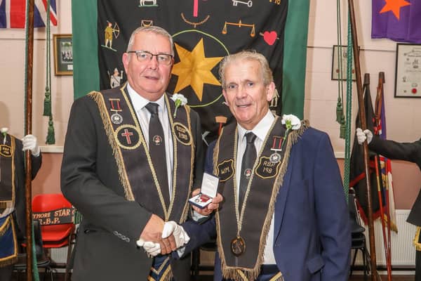 Neil McCarthy receiving a 40-year service jewel from Bryan Gamble, Worshipful Master of Largymore Star of the North RBP 198, prior to the lodge leaving for the Co Down Grand Chapter parade in Dromore on Saturday.