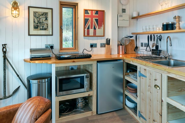 The galley kitchen is equipped with everything you need to whip up a romantic supper.