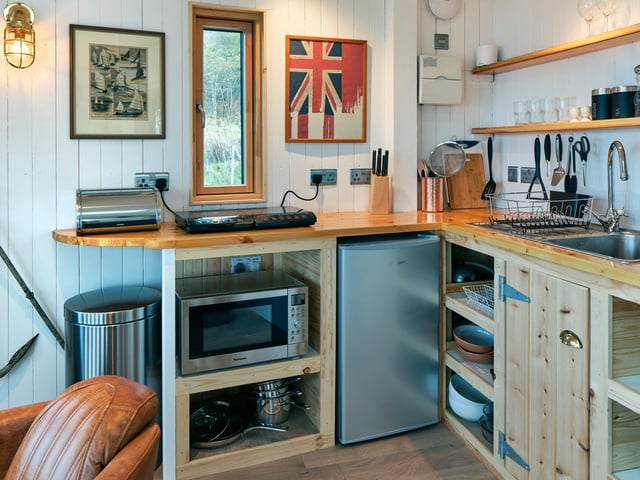 The galley kitchen is equipped with everything you need to whip up a romantic supper.