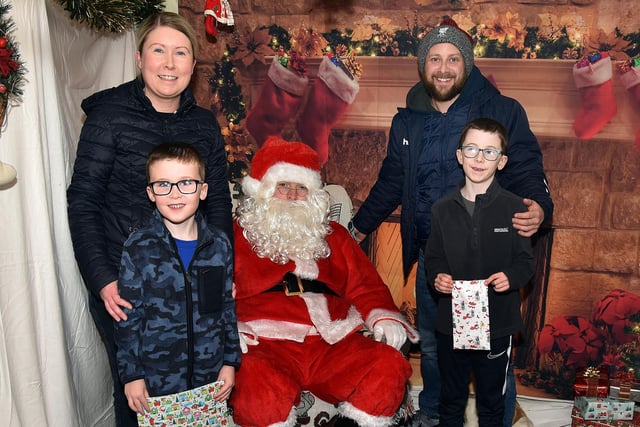 Pictured with Santa at The Cope Primary School, Loughgall, festive afternoon are Lisa and John Brownlee and their children, Sam (6) and Harry (8). PT51-202.