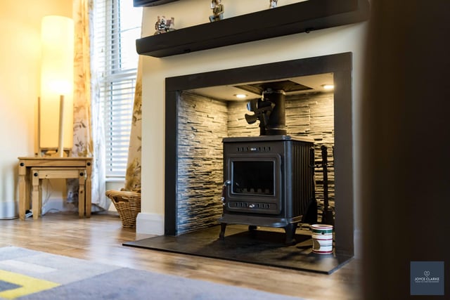 Spend cosy evenings at home beside this beautiful wood-burning stove with slate hearth, surround, tiled chamber and feature lighting.