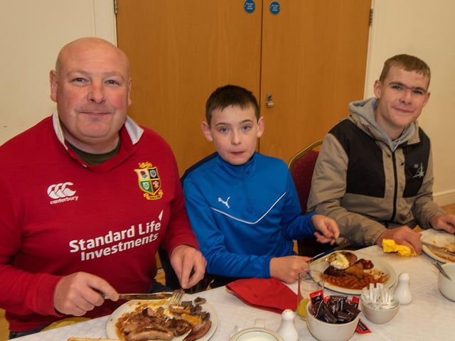Tucking in to their breakfasts are Aaron McCullough and sons Wallace and Jacob.