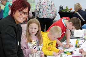 Woodvale residents Isobel Cully and family enjoy the activities at the opening of Bushmills and District Community Association’s community garden in Bushmills. CREDIT NIHE