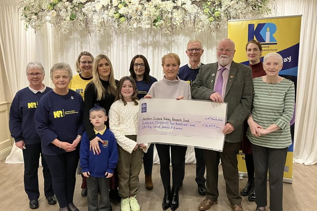Members of the McNeill family and members of the NI Kidney Research Fund join Caring Caretaker Davy Boyle and his wife Teresa at the cheque presentation event.
