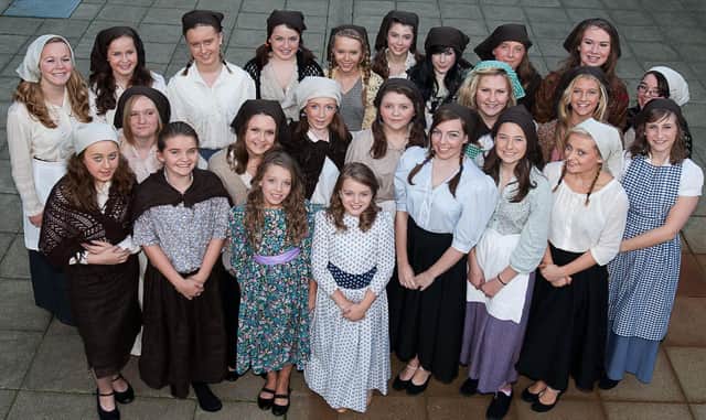 The 'Daughters'  and the chorus wait to take to the stage for the Wallace High School production of Fiddler on the Roof in 2010