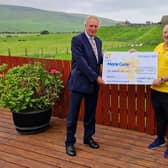 Mr Campbell Tweed presenting the cheque to Marie Curie Cancer Care.  Photo: David McMullan