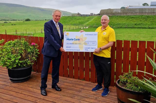 Mr Campbell Tweed presenting the cheque to Marie Curie Cancer Care.  Photo: David McMullan