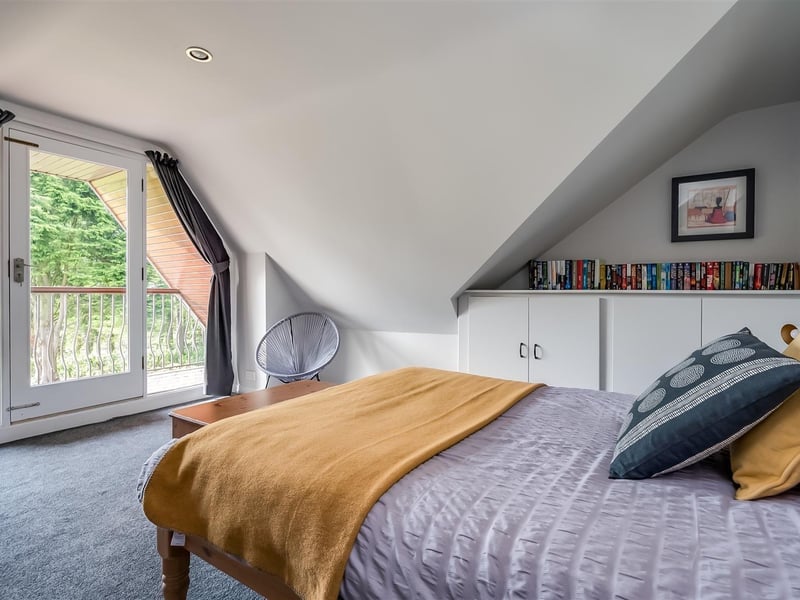 Bright and spacious bedroom with door leading to balcony.