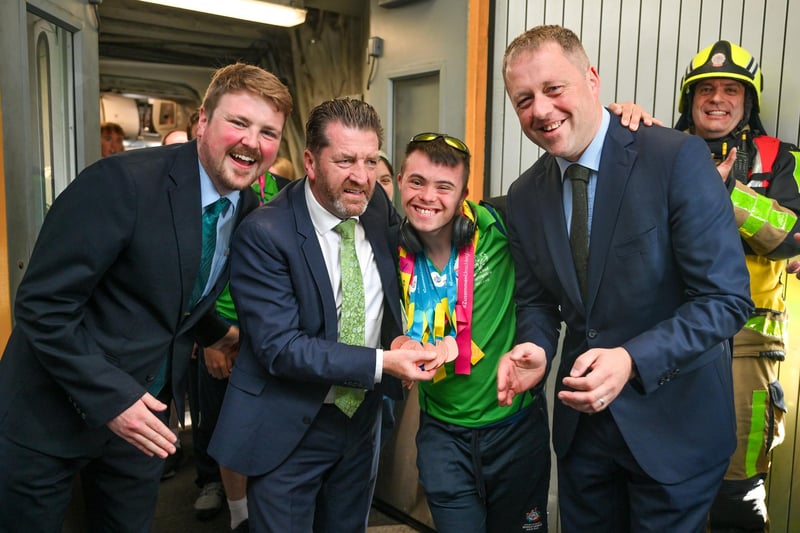 Team Ireland's Aaron Lenzi, a member of LX Gymnastics Club, from Ballynahinch, Co Down, is greeted by Daniel Hurley, left, senior cabin crew Aer Lingus; Matt English, CEO of Special Olympics Ireland and Minister of State at the Department of Tourism, Culture, Arts, Gaeltacht, Sport and Media Thomas Byrne TD at Dublin Airport on the team's return from the World Special Olympic Games in Berlin, Germany. Photo by: Ray McManus/Sportsfile