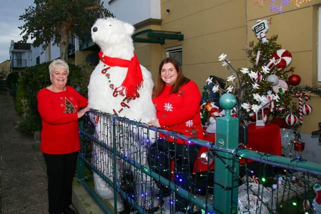 Clara and Cathy Smyth with 'Tucker' the polar bear at the Christmas garden near Carrick Marine.  Photo: Jackie Henry