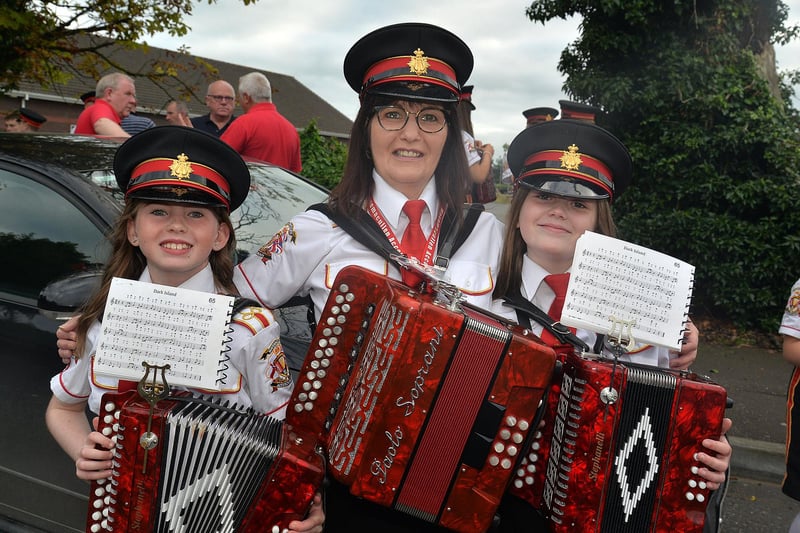 Mavemacullen Accordion Band bandmaster, Sharon Richardson pictured with young members, Lila McKee (9), left, and Poppy Marshall (10) at the band's 70th anniversary parade in Markethill on Wednesday night. PT32-225.