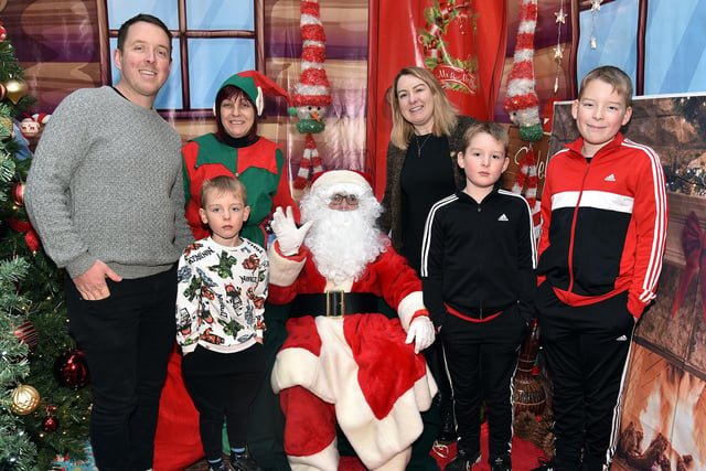 The Stewart family pictured with Santa and his elf. Included are from left, dad, Philip, Reuben (6), mum, Lynn, Nathan (8) and Izaac (11). LM50-215.