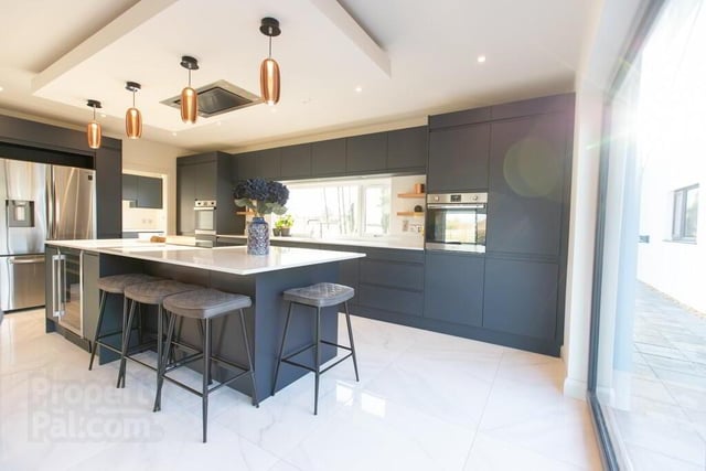 The impressive kitchen area is finished to a very high standard and in stylish shades.