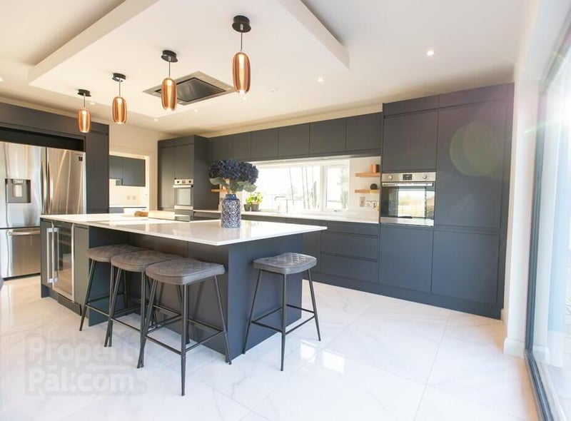 The impressive kitchen area is finished to a very high standard and in stylish shades.