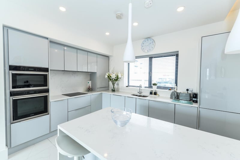 Modern fitted kitchen with high gloss units.