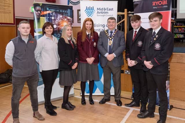 Peter McMullan, Ryobi apprentice; Gwyneth Evans, human resources manager, Ryobi; and the Mayor of Mid and East Antrim, Alderman Noel Williams, with Carrickfergus Grammar School Pupils, during a visit by Ryobi representatives to the school as part of Northern Ireland Apprenticeship Week.