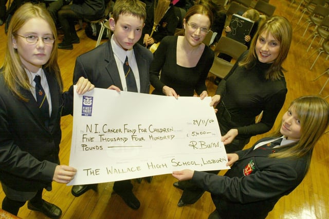 Wallace High School pupils Jessica Watt, Jordan Clements and Kathryn Farley  presenting a cheque for £5400 to Rachel Smyth  from  the Northern Ireland Cancer Fund for Children in 2006. Also pictured is special guest Sarah Travers from BBC NI