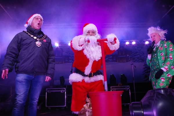 Santa switching on the lights at Dungannon assisted by Mid Ulster District Council Chairperson Cllr Dominic Molloy.