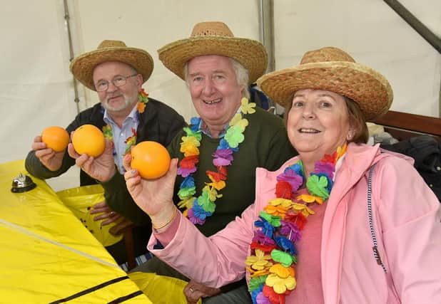 Three members of Portadown Rotary Club who were fundraising at Country Comes To Town  wth their 'Human Fruit Machine' game. Included from left are, Paddy Haughain, Wilbert McKee and Ursula Boyle. PT41-201.