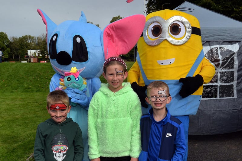 Posing with cartoon characters at the charity fun day at Laurelvale Cricket Club are, from left, Bentley Muldrew (6), Julia Topley (10) and Robert Topley (7). PT39-216.