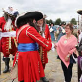 The Mayor of Mid and East Antrim Borough Council, Alderman Gerardine Mulvenna, meets some of the main characters at the Siege of Carrickfergus.