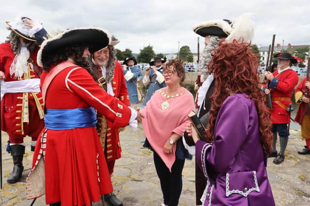 The Mayor of Mid and East Antrim Borough Council, Alderman Gerardine Mulvenna, meets some of the main characters at the Siege of Carrickfergus.