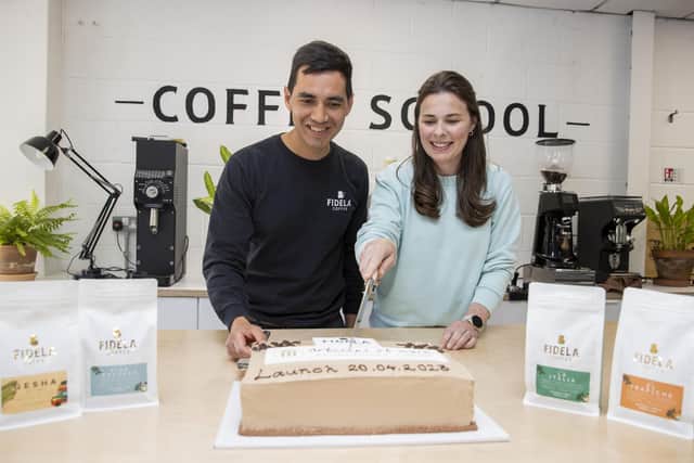 Rachel Dillon and Frank Portilla, owners of Fidela Coffee Roasters cutting the cake to celebrate