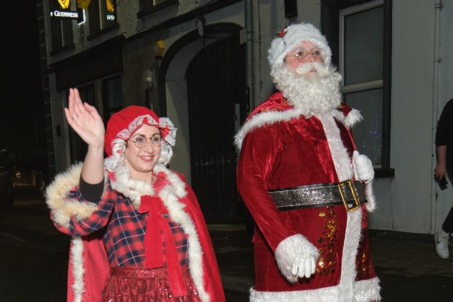 Festive visitors greet the crowds.