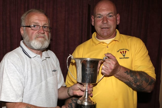 Johnny Campbell, Chairman of the Ballymoney Darts League, pictured presenting the League championship trophy to Peach Traynor cpt of the Manor Hotel Darts team back in 2008. The players dedicated the award to the late Joe Rice