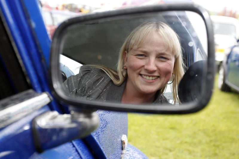 Joanne Caldwell looks in the door mirror of her Mini at the Mini Festival in Portrush in 2009