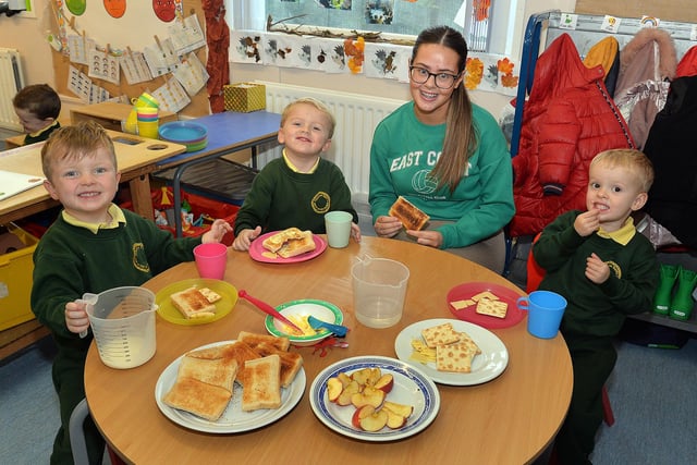 Enjoying their toast and milk at breaktime in Naíscoil Na Banna with naíscoil assistant, Mia McPoland are pupils from left, Conn, Elan and Finn. PT43-302.