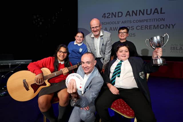 Children's entertainer Caolan McBride, Councillor Tim Mitchell and some of the young people who enjoyed the Lisburn & Castlereagh City Council's 42nd Annual Schools' Arts Awards held in Lisburn. Pic credit: Steven McAuley/McAuley Multimedia