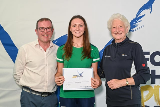 Hockey player Rebekah Lennon, from Portadown, receiving her Mary Peters Trust award certificate from Barry Funston and Lady Mary Peters. Photo submitted by Mary Peters Trust