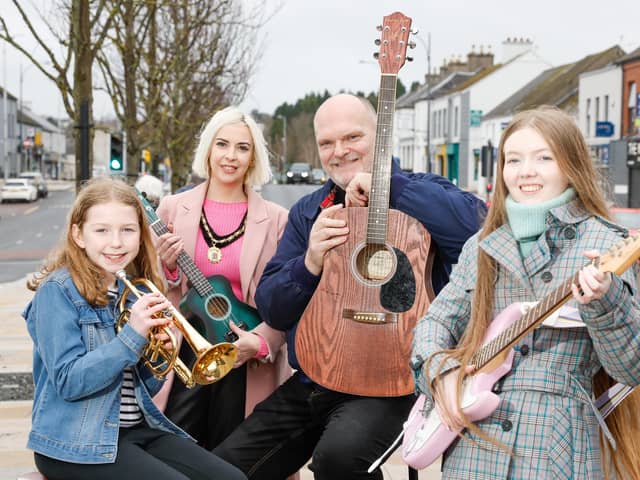 Deputy Lord Mayor of Armagh City, Banbridge and Craigavon Councillor Sorchá McGeown and Ralph McLean, BBC Radio Ulster Presenter pictured with two young buskers.