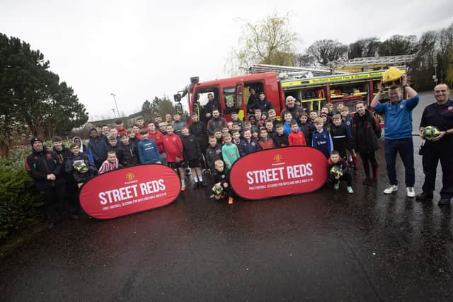 STREET REDS!. . . . .Officers from the Northern Ireland Fire and Rescue Service pictured at the Manchester United Foundation 'Street Reds Easter Soccer Festival' at Oakgrove Integrated College. Included are Foundation representatives and Pat McGibbon, ex-Manchester United player and founder of Train 2B Smart mental health charity. (Photos: Jim McCafferty Photography)