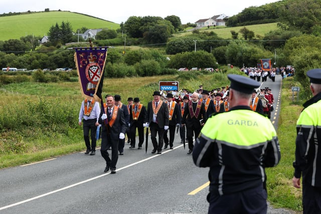 Garda officers watch Orangemen and supporters take part in the annual Rossnowlagh procession.