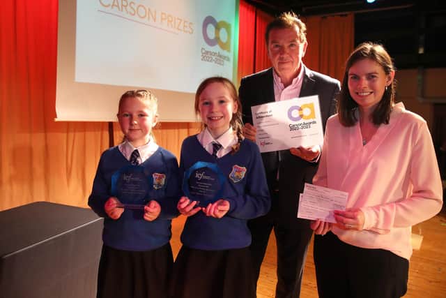 Phoenix IPS pupils and teacher receiving their Carson Award from co-founder Tony Carson. Credit: Declan Roughan