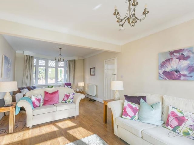 The large living room at the Robin Down Lane property from a different angle. A particularly appealing feature is the bay window at the front, which allows natural light to flood through.